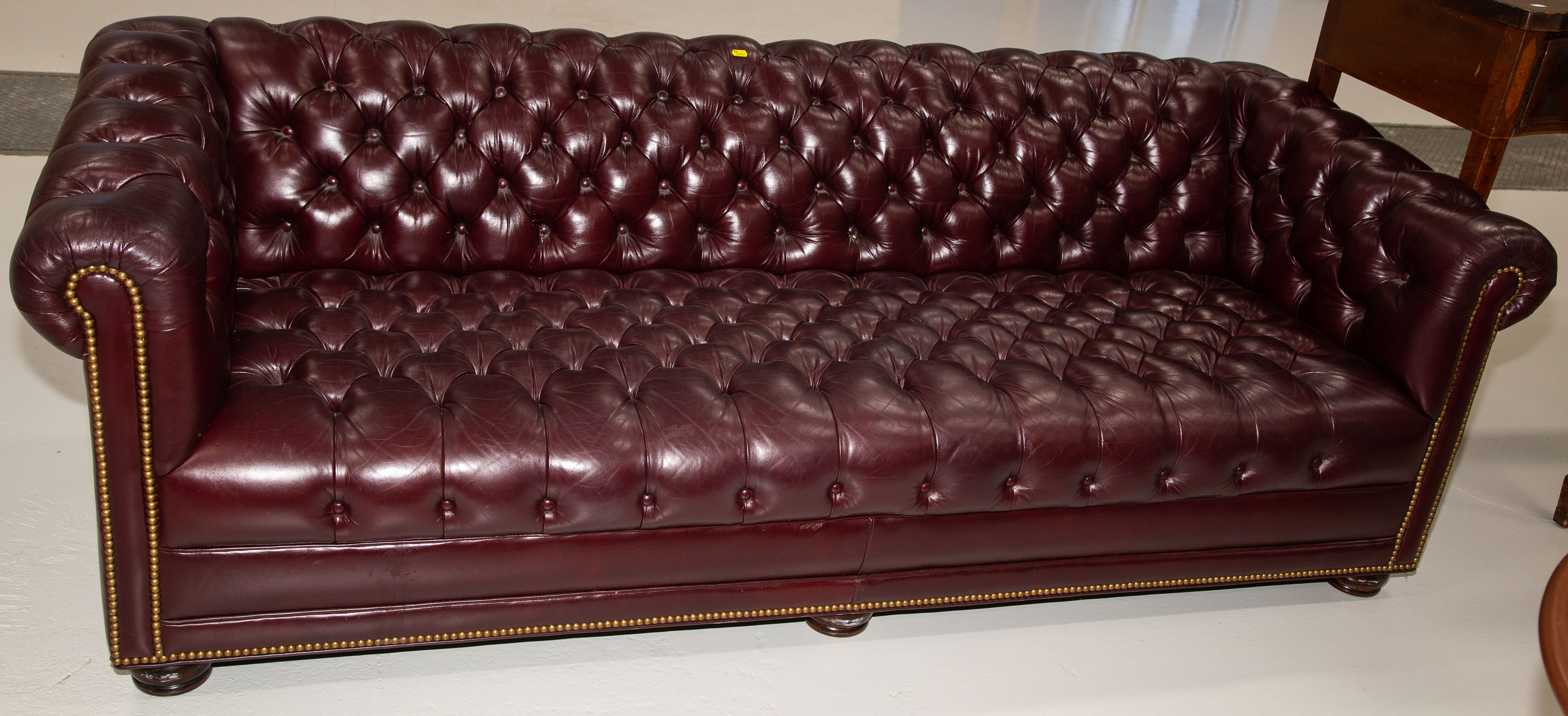 A TUFTED LEATHER SOFA Possibly