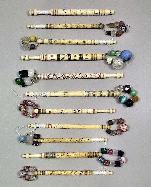 A turned bone lace bobbin worded in
