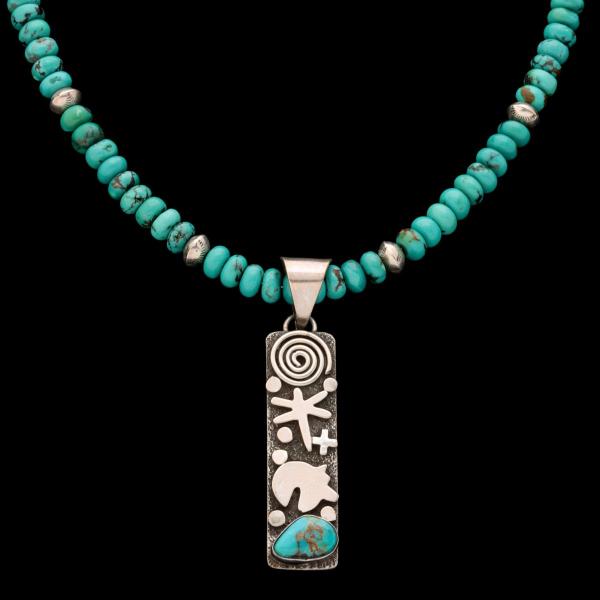 A TURQUOISE BEAD NECKLACE WITH ALEX