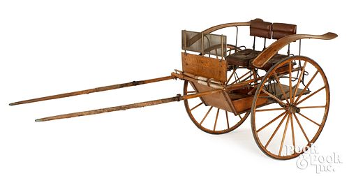 A TWO WHEELED SULKY HORSE DRAWN