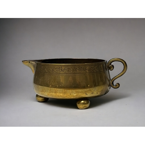 A Victorian brass milk jug.Squat