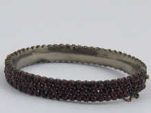 A Victorian garnet bangle set in
