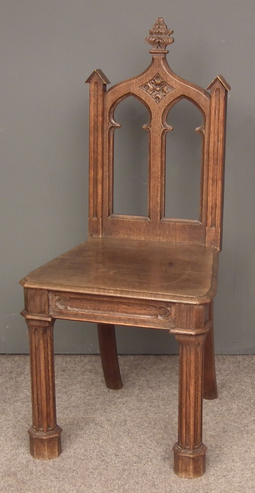A Victorian oak hall chair of