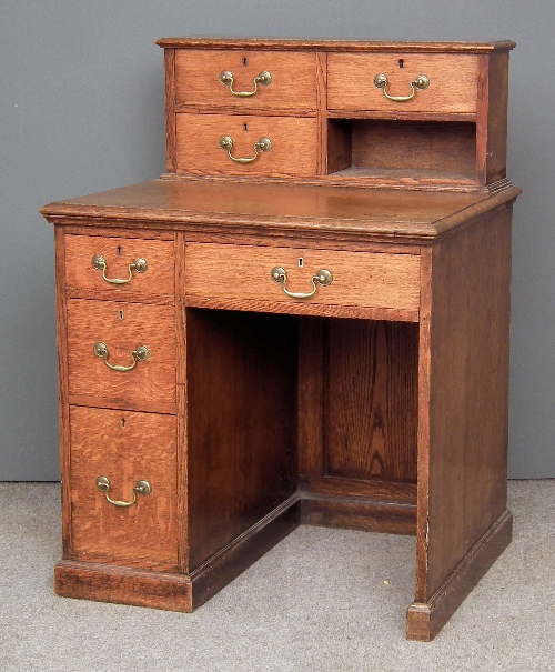 A Victorian oak kneehole desk the