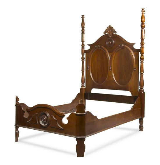 * A Victorian Walnut Bed having a