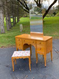 A vintage birdseye maple vanity