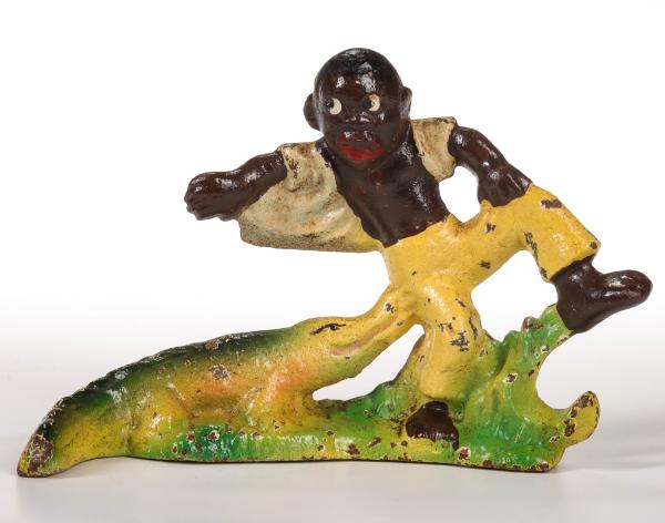 A VINTAGE FIGURAL IRON BOTTLE