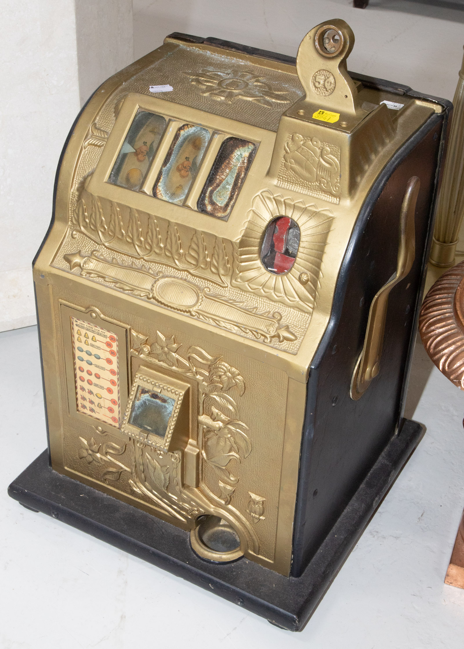 A VINTAGE FIVE CENT SLOT MACHINE