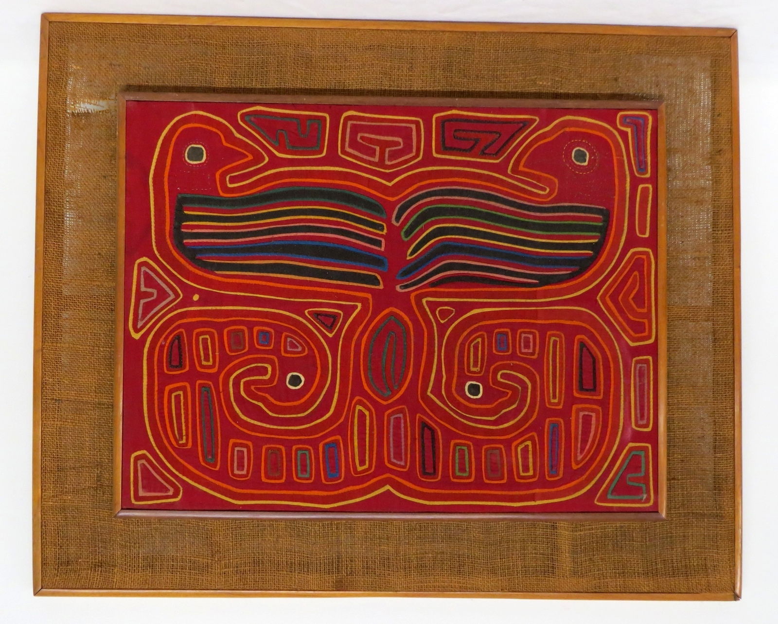 A VINTAGE FRAMED KUNA MOLA TEXTILEA