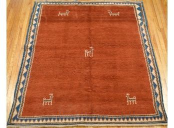 A vintage Gebbeh area rug with a