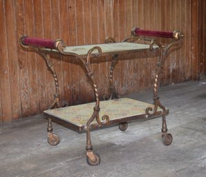 A vintage iron bar cart with nicely
