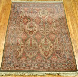 A vintage machine made area rug, in