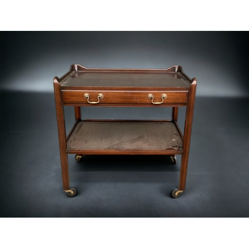 A VINTAGE MAHOGANY TEA TROLLEY.