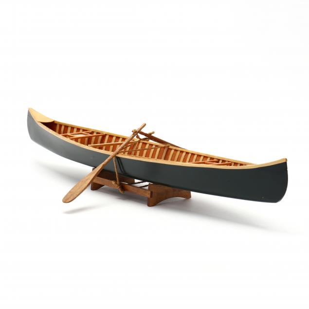 A VINTAGE MODEL OF A CANOE 20th