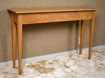 A vintage oak sofa table with a