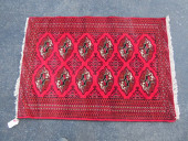 A VINTAGE PERSIAN BOKHARA RUG<