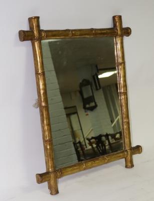 A wall mirror with a gilded