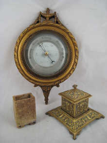 A wall mounted aneroid barometer in