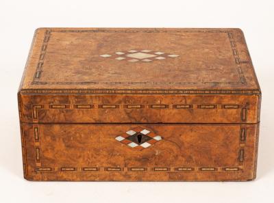 A walnut inlaid box containing