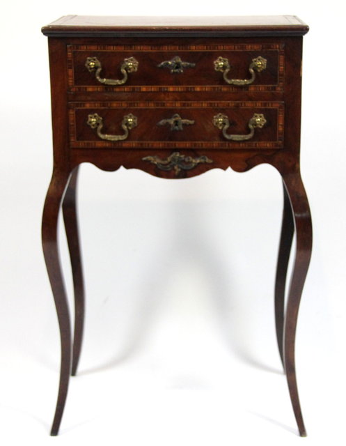 A walnut two-drawer table the