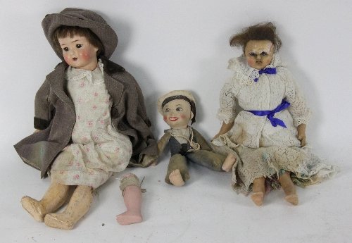 A wax head doll wearing a white