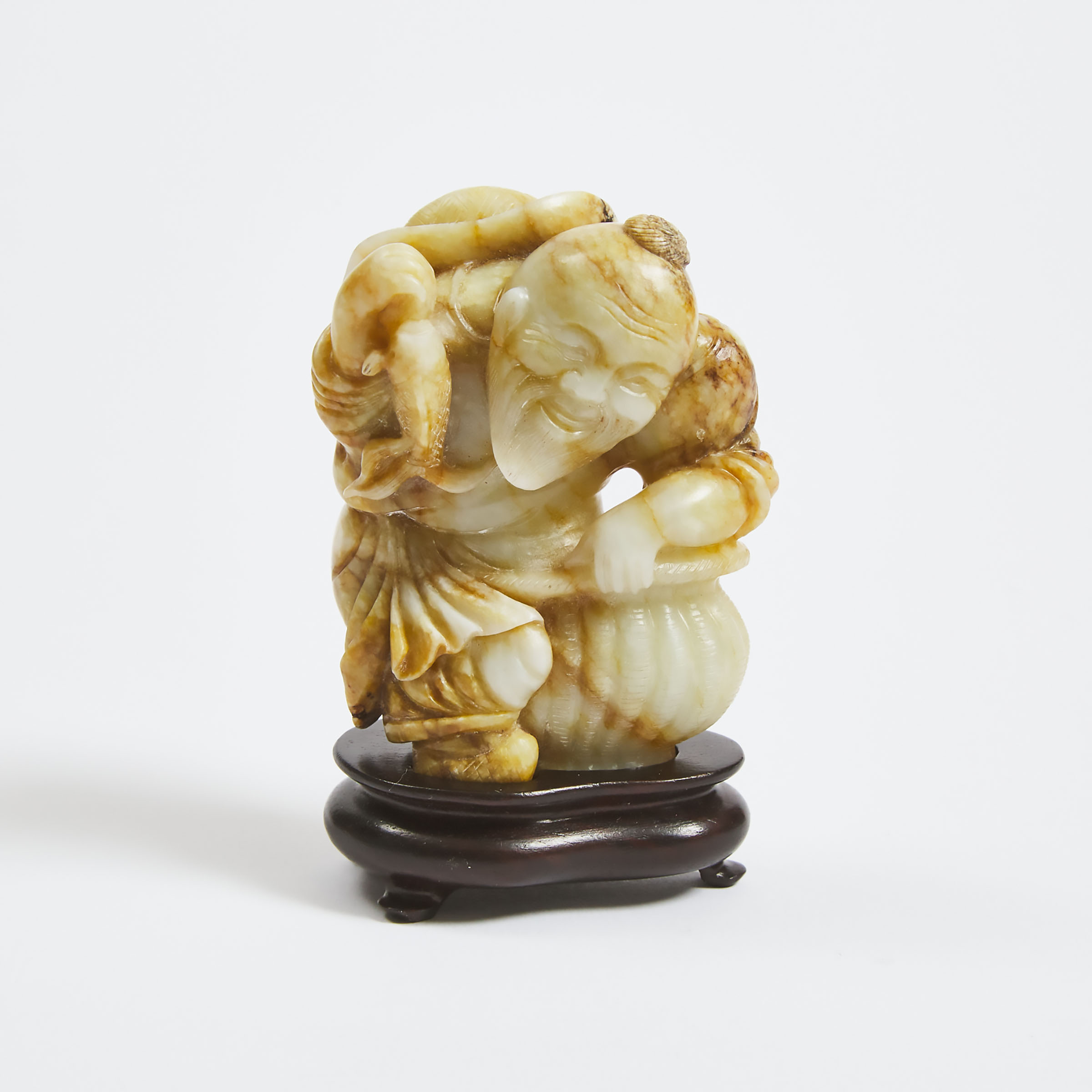A White and Russet Jade Figure of a