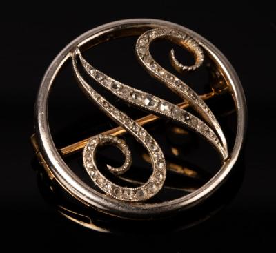 A white gold and diamond initial