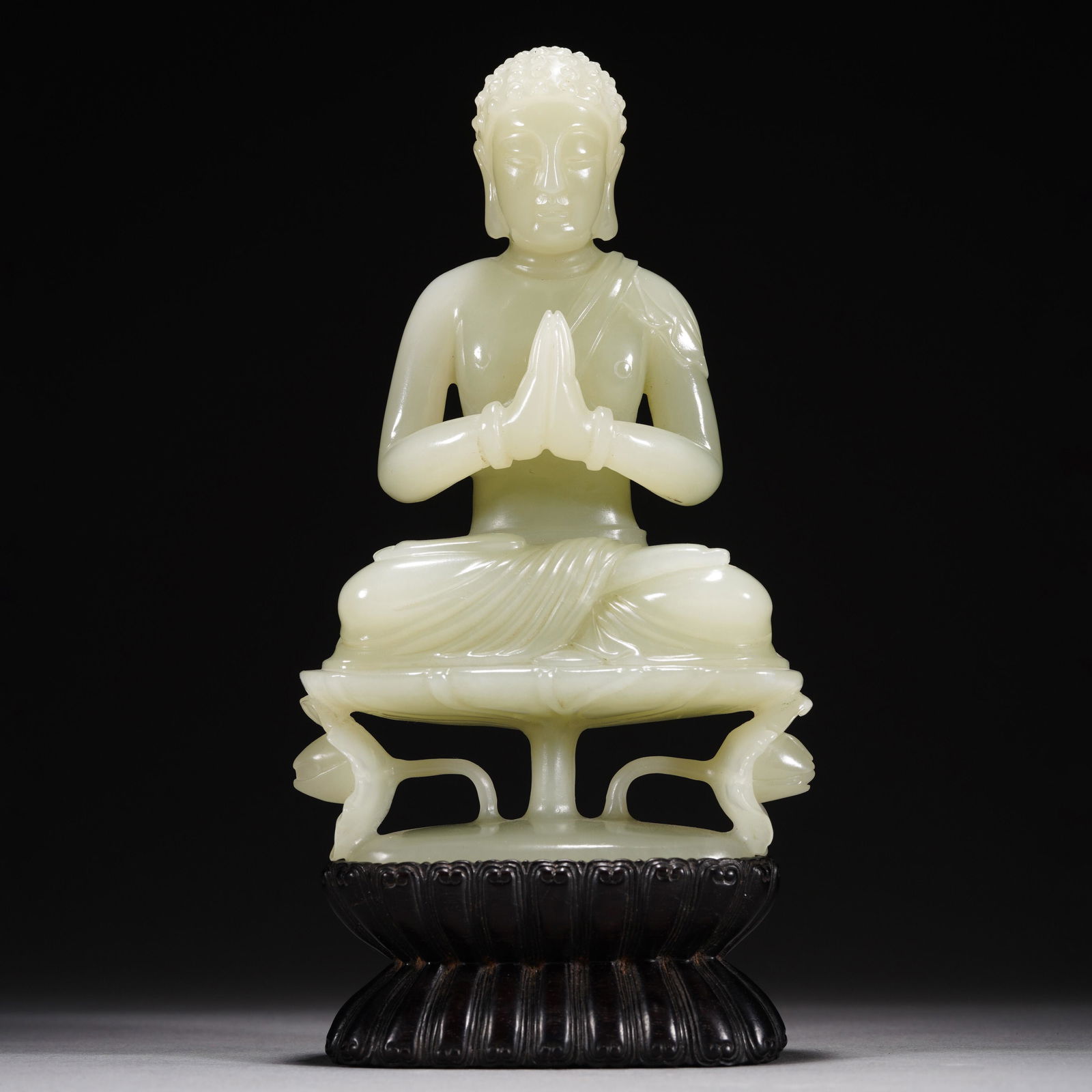A WHITE JADE FIGURE OF BUDDHA