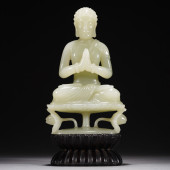 A WHITE JADE FIGURE OF BUDDHA