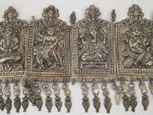 A white metal frontal with embossed