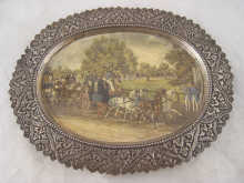 A white metal oval dish with