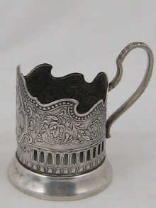A white metal Russian tea glass