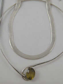 A white metal (tests silver) gem