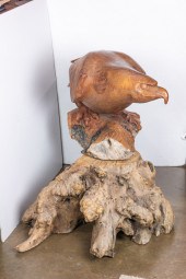 A WOOD CARVED EAGLE MOUNTED ON