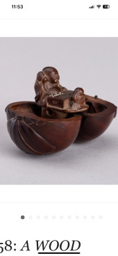 A WOOD KARAKURI NETSUKE WITH A