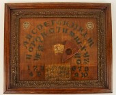 A WOOD OUIJA BOARD IN AN OAK F