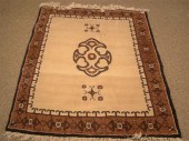 A WOOL ISLAMIC RUG A brown and