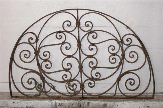 A Wrought Iron Arched Transom Grill