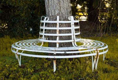 A wrought iron circular slatted