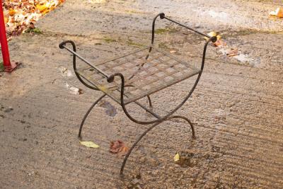 A wrought iron garden seat with