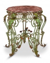 A WROUGHT IRON TABLE WITH MARB