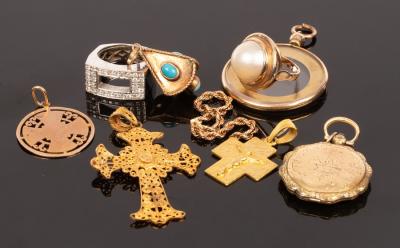 A yellow metal crucifix pendant,