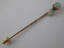 A yellow metal (tests gold) and