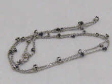 An 18 carat white gold chain set