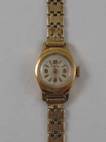 An 18 ct gold lady's wrist watch on