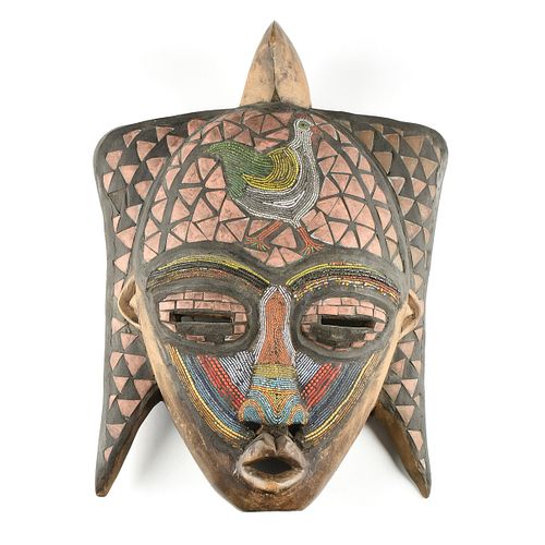 AN AFRICAN BEAD AND COPPER INLAID