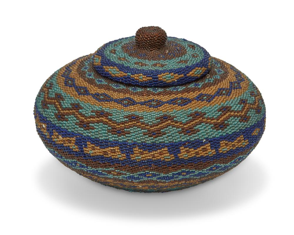 AN AFRICAN BEADED BASKETAn