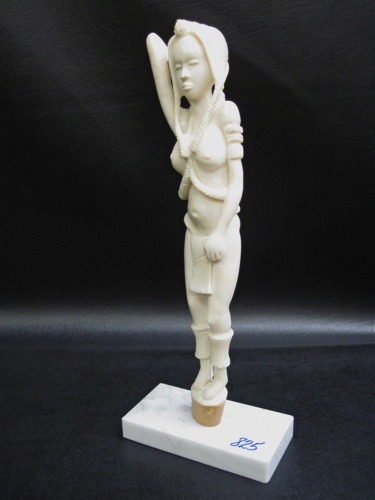 AN AFRICAN IVORY CARVED FIGURE of