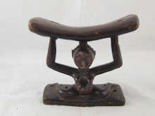 An African neck rest carved as a