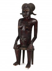 AN AFRICAN TRIBAL WOOD SEATED
